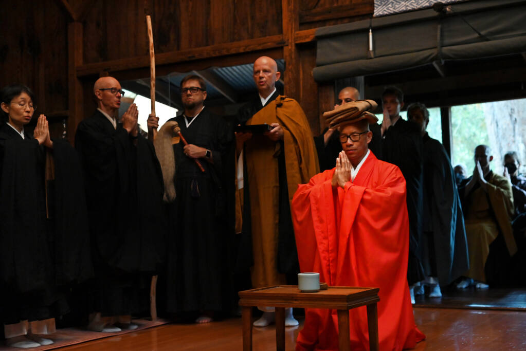 New abbot Nyoze Kwong, right in red, during a portion of the mountain seat ceremony which marks the transition between the retiring and incoming abbot held Saturday, September 2, 2023 at the Sonoma Mountain Zen Center in Santa Rosa. (Erik Castro / For The Press Democrat)