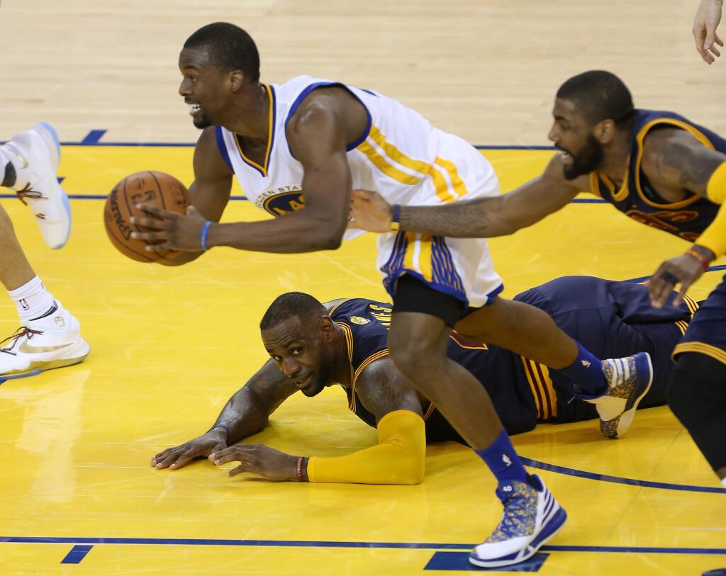 Golden State Warriors' Harrison Barnes grabs a loose ball from Cleveland Cavaliers' LeBron James and Kyrie Irving, during their game in Oakland on Sunday, June 5, 2016. The Warriors defeated the Cavaliers 110-77.(Christopher Chung/ The Press Democrat)