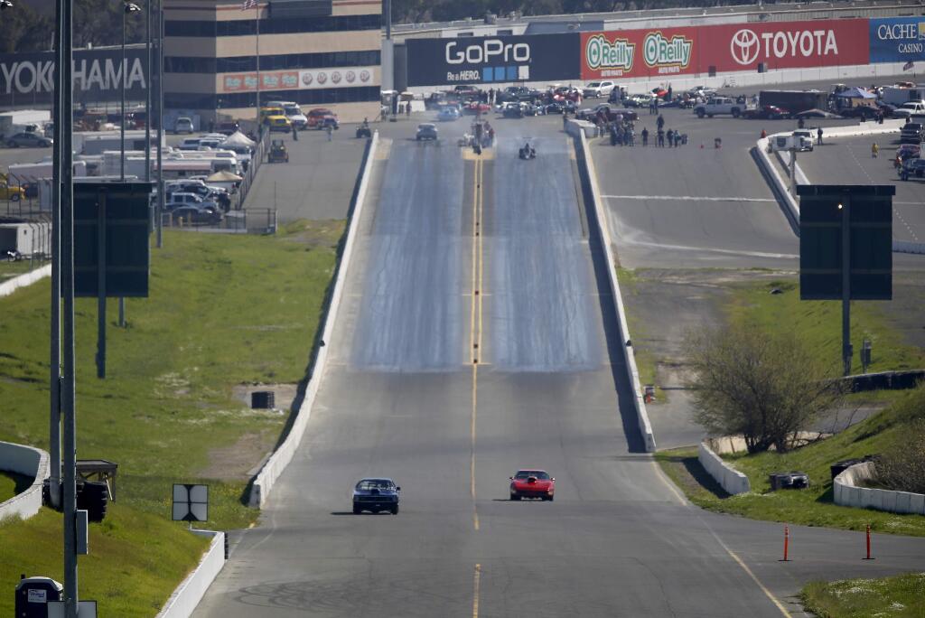Cars race down the track at Sonoma Raceway on Monday, February 16, 2015 in Sonoma, California . (BETH SCHLANKER/ The Press Democrat)