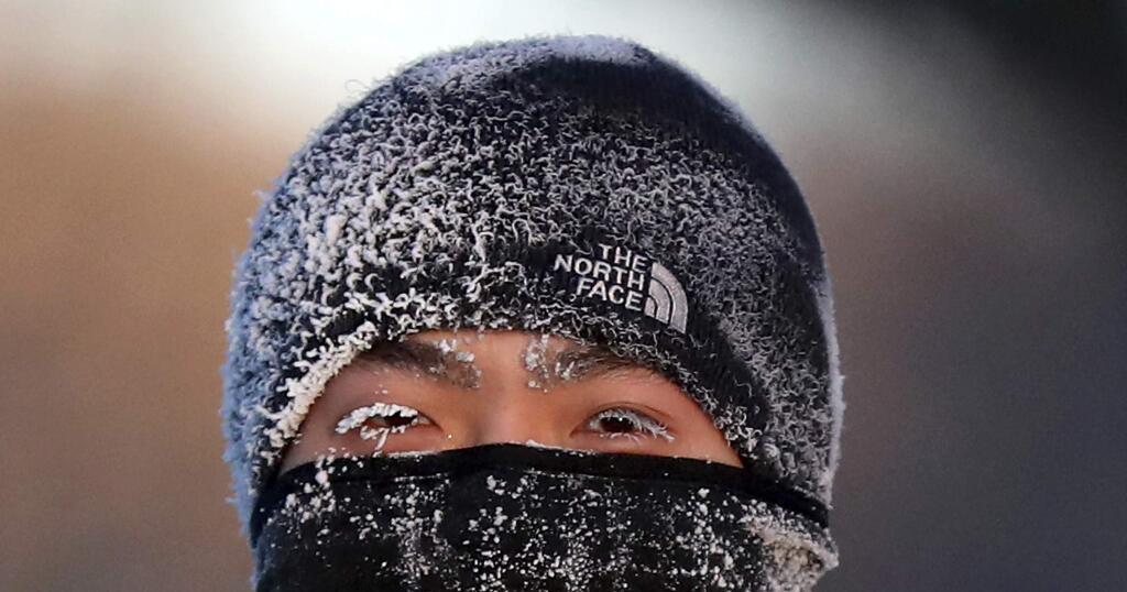 A runner wears the cold on his face while running along West River Parkway hills Thursday, Feb. 13, 2020, near downtown Minneapolis, with temperatures hovering near minus 30 degrees Fahrenheit with wind chills. (David Joles/Star Tribune via AP)