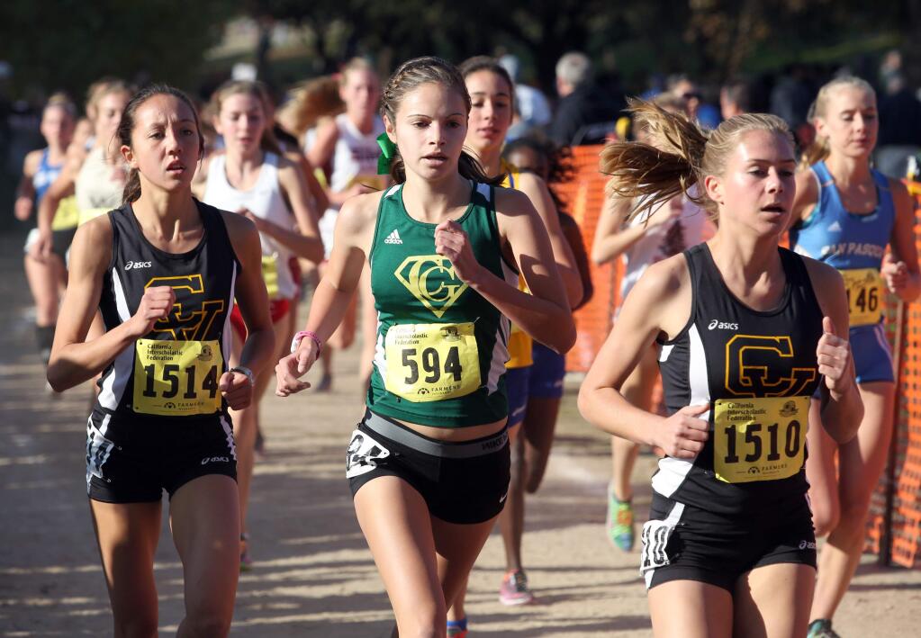 Casa Grande's Adria Barich , center, runs with Capistrano Valley's Mikaela Mulhall, left, and Rebecca Deitch in the Division 2 race during the 2014 CIF State Cross Country Championships held at Woodward Park in Fresno, Saturday, Nov. 29, 2014. (Crista Jeremiason/The Press Democrat)