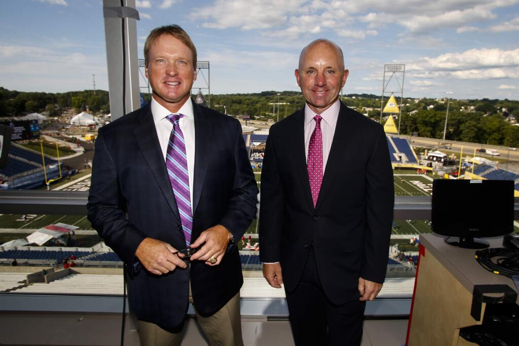 FILE - In this Aug. 7, 2016, file photo, ESPN Monday Night Football announcers Jon Gruden, left, and Sean McDonough stand in the press box of Tom Benson Hall of Fame Stadium before a preseason NFL football game between the Green Bay Packers and the Indianapolis Colts, in Canton, Ohio. Eleven years after the network telecast an NFL game from Mexico City, it will do so again when the Raiders 'host' the Texans on Monday night. Gruden has become something of a rock star in the NFL broadcasting world, and while his main job is to dissect play on the field, it will be intriguing to hear his take on not only the game, but the entire scene Monday night. (AP Photo/Gene Puskar, File)