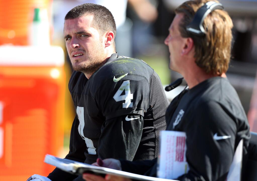 Oakland Raiders quarterback Derek Carr watches the game from the bench while his defense is on the field against the Houston Texans during their game in Oakland on Sunday, September 14, 2014. The Texans defeated the Raiders 30-14.(Christopher Chung/ The Press Democrat)
