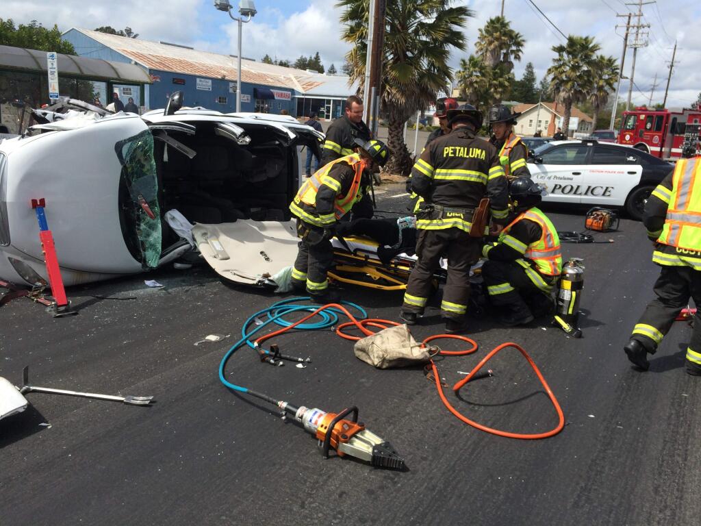 Firefighters extricated a woman who crashed her minivan and overturned on Petaluma Boulevard North in Petaluma on Sunday, April 5, 2015. (COURTESY OF JEFF SCHACH)