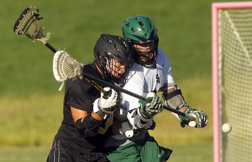 Windsor's Jack Yeager, left, and Matt Clark fight for a loose ball. The Windsor High boy's lacrosse team beat Sonoma Academy, 6-5, on Friday, April 27, 2015. (Photo by John Burgess/The Press Democrat)