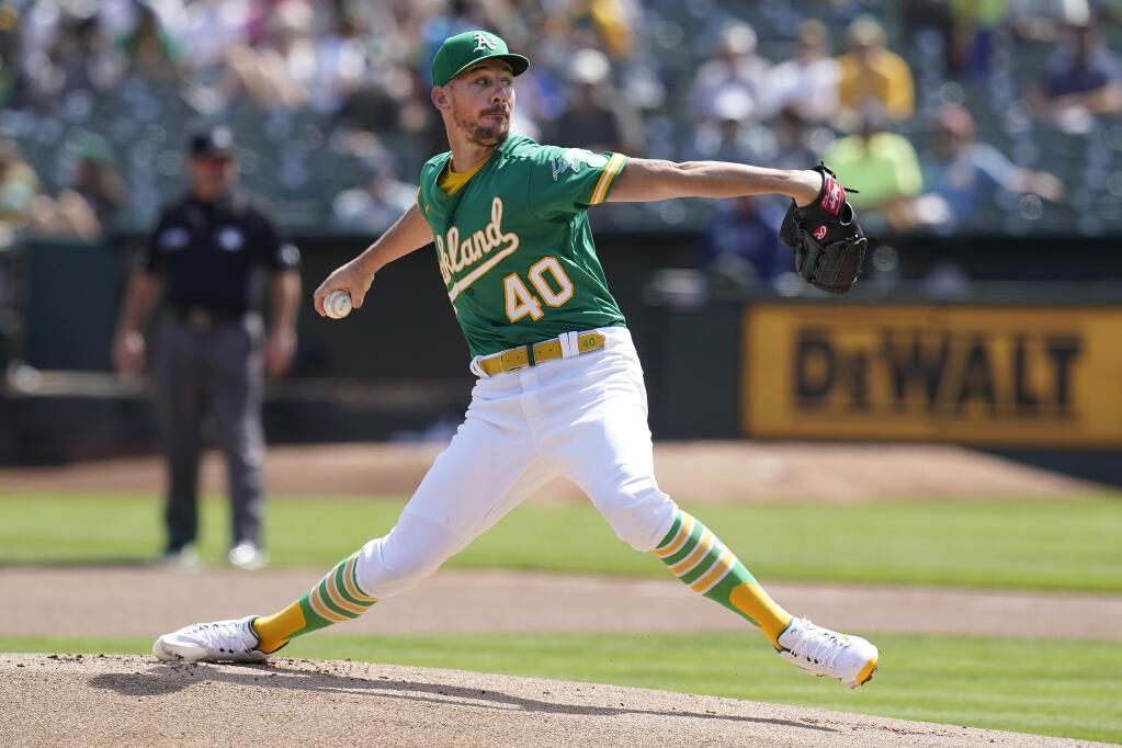 The Oakland Athletics’ Chris Bassitt pitches against the Seattle Mariners during the first inning in Oakland on Thursday, Sept. 23, 2021. (Jeff Chiu / ASSOCIATED PRESS)