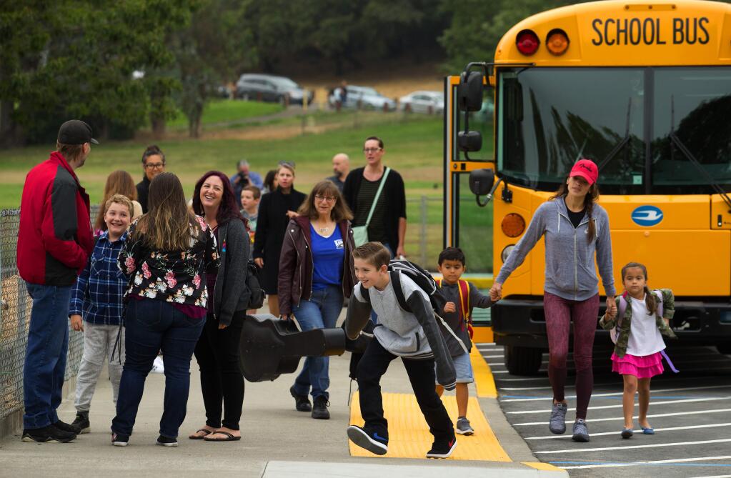 (FILE PHOTO) Families gather to reconnect in the drop-off area at Hidden Valley Elementary School in Santa Rosa on the first day of the school year in 2018. (John Burgess/The Press Democrat, 2018)