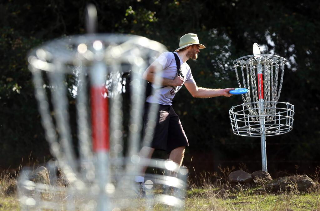 Zack Creighton has a tap in putt after his disc landed a foot from the hole. The Taylor Mountain Disc Golf Course built by the United Flyers of Sonoma opened in the open space preserve in Santa Rosa on Saturday.