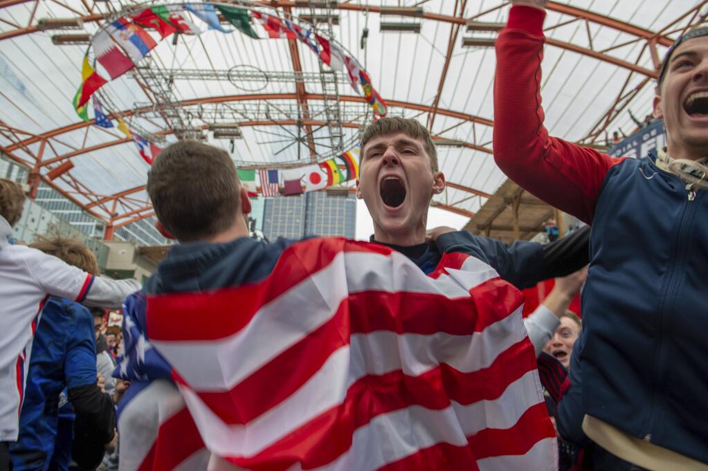 Peyton Olson, center, reacts to a goal scored by the United States during the Qatar World Cup group B soccer match against Iran, in Kansas City, Missouri. (Emily Curiel/The Kansas City Star via AP)