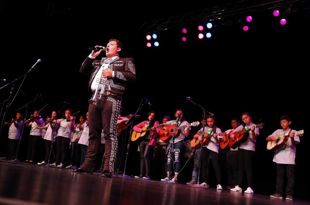 Jose Soto, of Mariachi Barragan, sings along with children from the Mariachi Summer Camp, during a Los Cien event at the Luther Burbank Center for the Arts, in Santa Rosa on Friday, August 25, 2017. (Christopher Chung/ The Press Democrat)