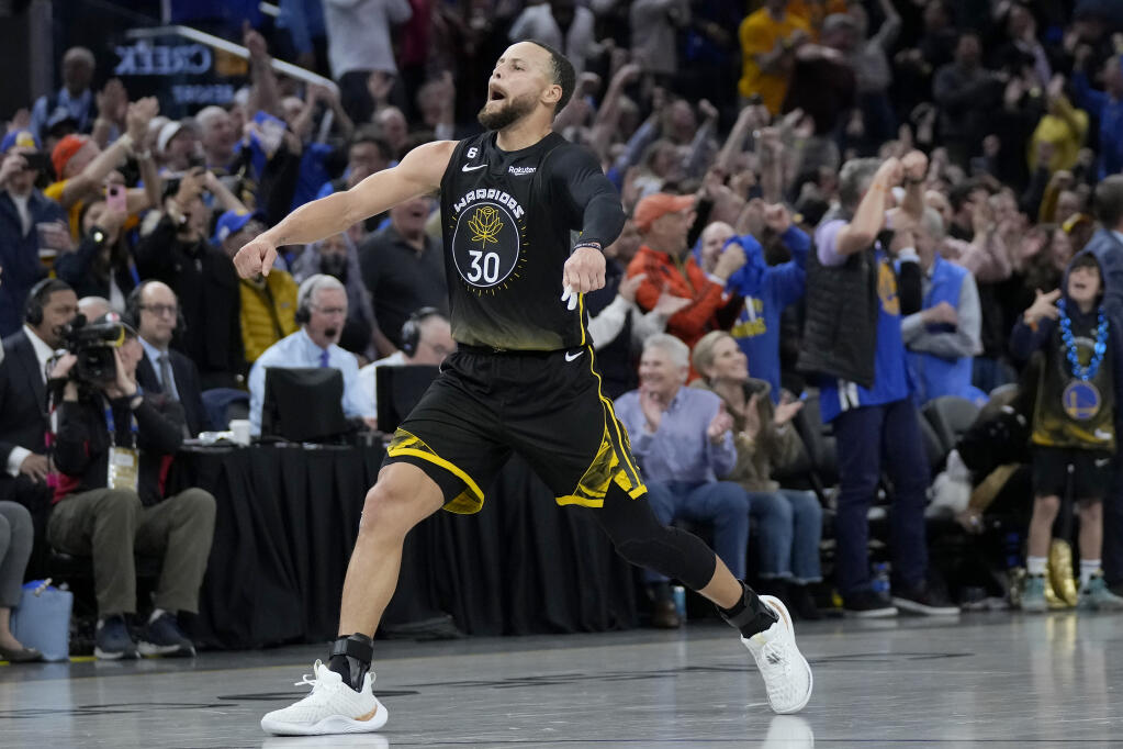 Warriors guard Stephen Curry reacts after making a 3-point basket during the second half against the Milwaukee Bucks in San Francisco, Saturday, March 11, 2023. (Jeff Chiu / ASSOCIATED PRESS)