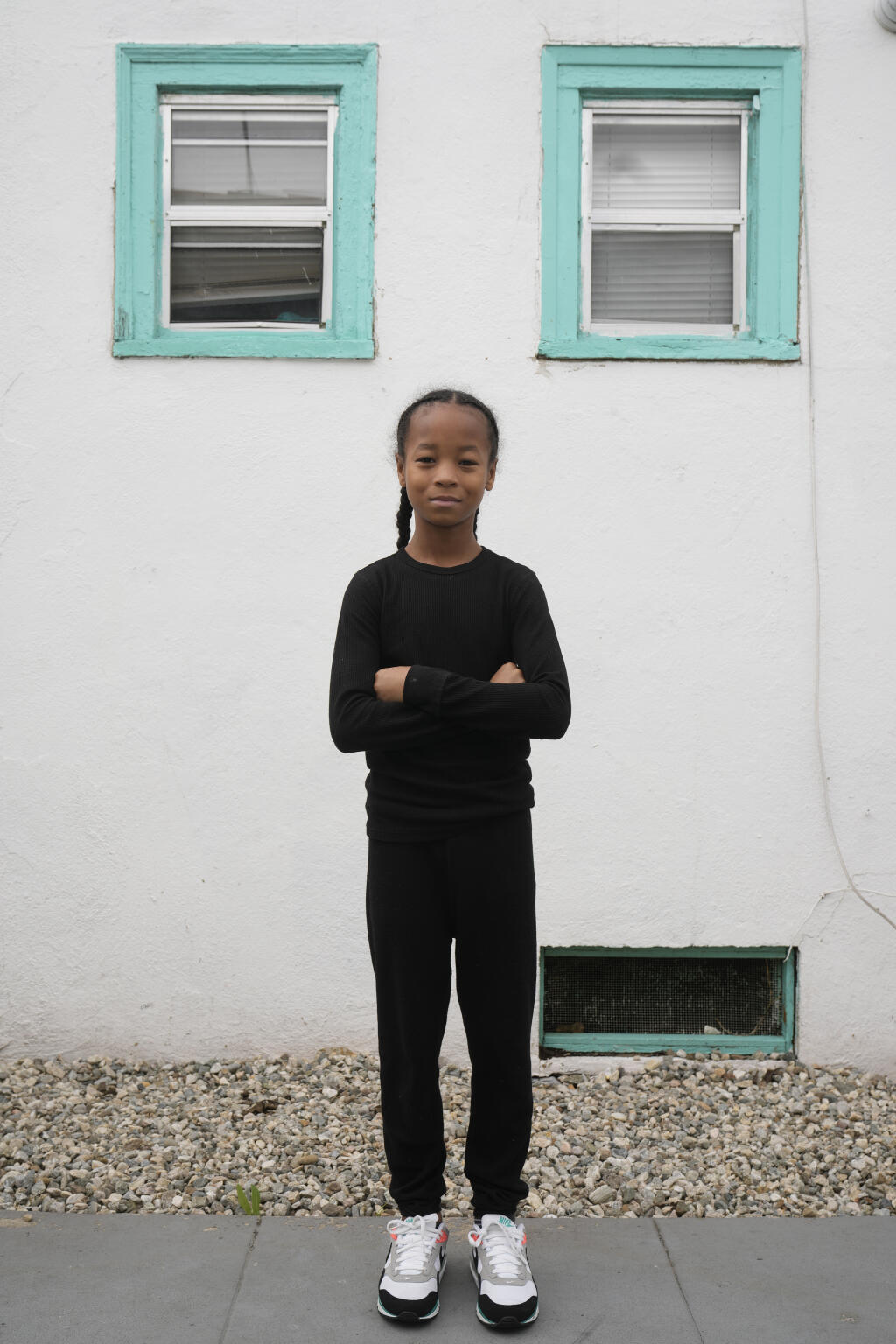 Ezekiel West, 10, stands for a portrait outside his home in Los Angeles on Sunday, Jan. 15, 2023. When he returned to school in fall 2021 as a third grader, he was frustrated that his classmates had made more progress as the years passed. “I did not feel prepared,” he says. “I couldn’t really learn as fast as the other kids, and that kind of made me upset.” (AP Photo/Damian Dovarganes)