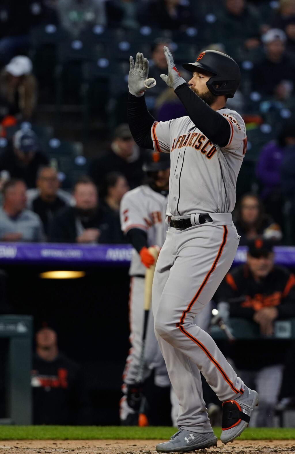 The San Francisco Giants' Mac Williamson celebrates a three-run home run against the Colorado Rockies during the fourth inning, Tuesday, May 7, 2019, in Denver. (AP Photo/Jack Dempsey)