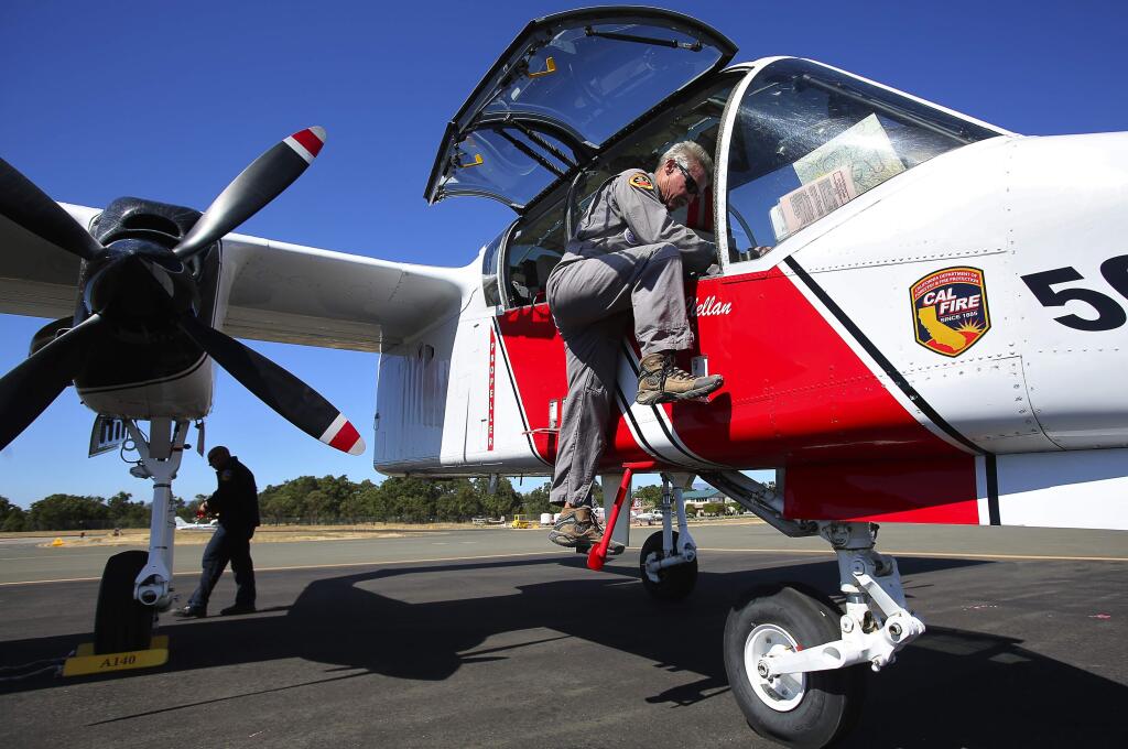 CDF Air Tactical Pilot Rick Haagenson exits the cockpit of an OV-10A Bronco as he returns to the CAL FIRE Sonoma Air Attack Base, after fighting the Rocky Fire in Lake County, on Monday, August 3, 2015. (Christopher Chung/ The Press Democrat)