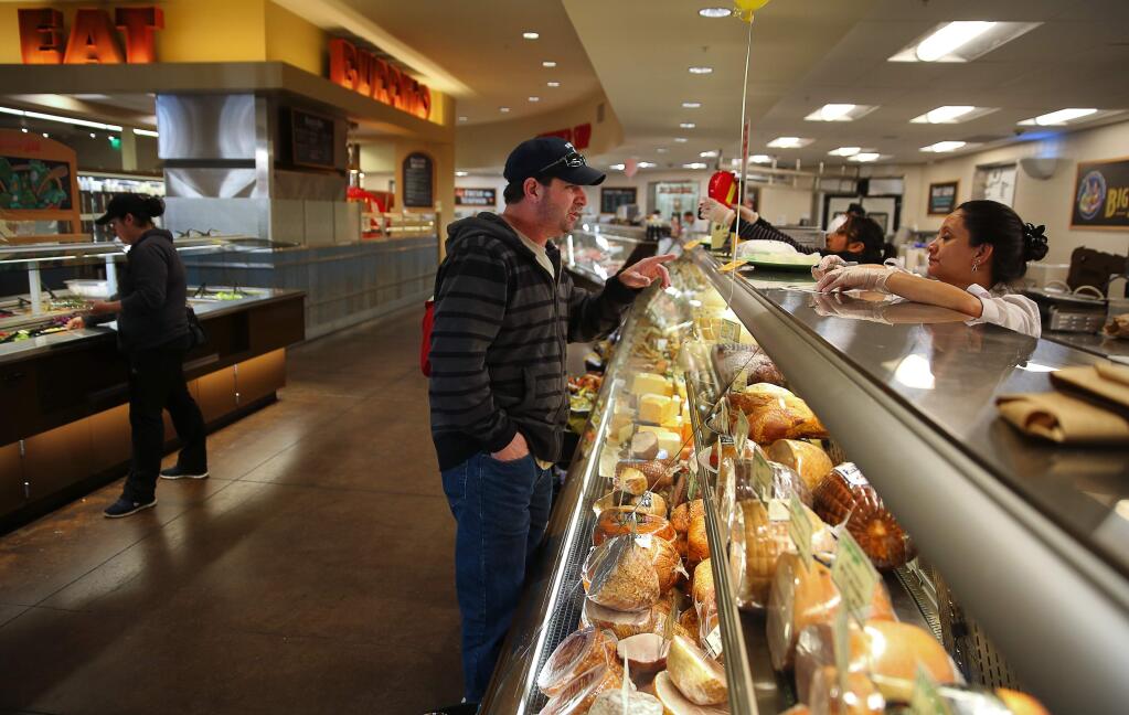 Angelo Cosentino, left, places an order for sandwich with Irma Guterriz at the deli counter in Big John's Market in Healdsburg on Wednesday, February 22, 2017. (Christopher Chung/ The Press Democrat)