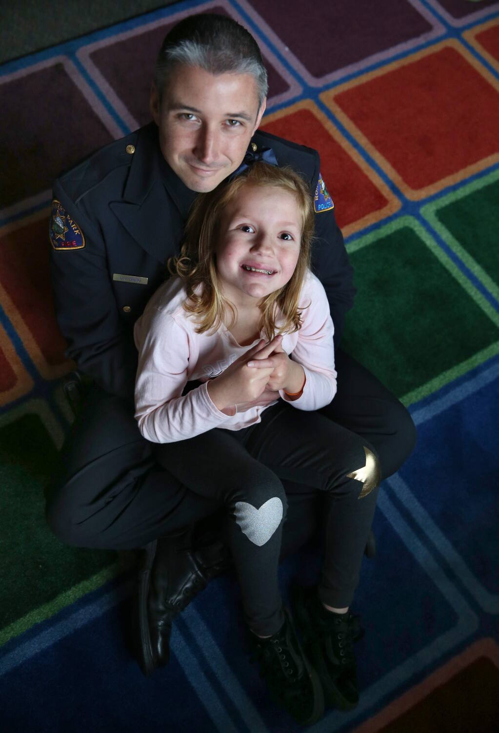 Rohnert Park police detective Duaine Labno with his step-daughter Madison Galvez, 9, who has autism at John Reed Elementary School on Wednesday, January 16, 2019 in Rohnert Park, California . (BETH SCHLANKER/The Press Democrat)