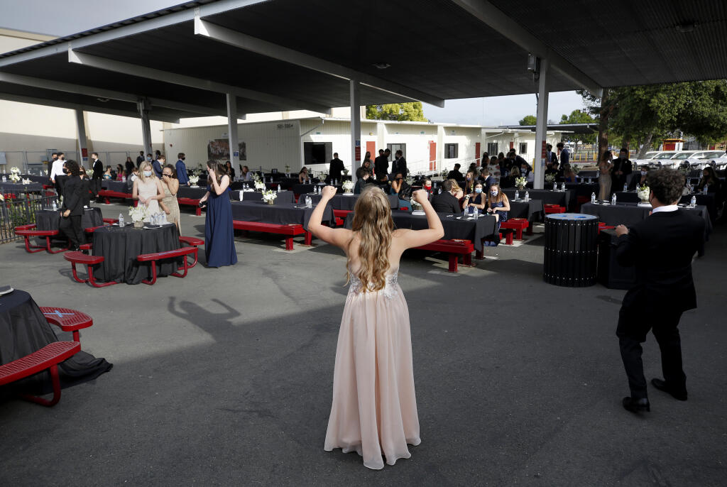 Seniors Ally Ostheimer and Bailey Ayre, right, try to lead the Macarena dance during prom at Cardinal Newman High School in Santa Rosa on Friday, April 23, 2021. (Beth Schlanker/ The Press Democrat)