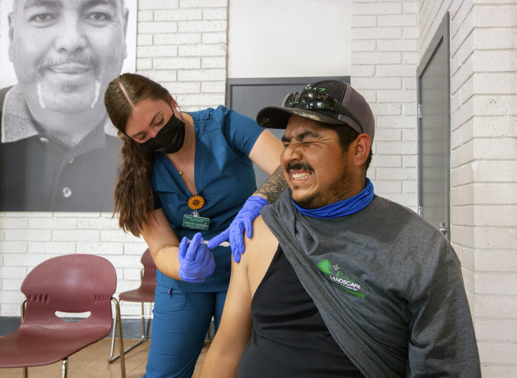 “First Shot” took first place in the California Journalism Awards News Photo category. Manuel Ramora Ramirez gets his first vaccine from medical assistant Joslynn Kurzhal, from the Sonoma Valley Community Health Center, at Booker Hall, the La Luz multi-purpose room, in Boyes Hot Springs on Friday, July 16, 2021. (Photo by Robbi Pengelly/Index-Tribune)