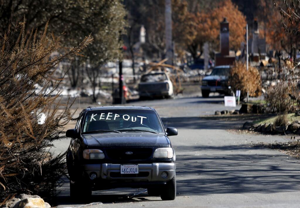 A message for people to stay away is marked in tape on a SUV on Parker Hill Road in Santa Rosa, on Tuesday, November 7, 2017. (BETH SCHLANKER/ The Press Democrat)