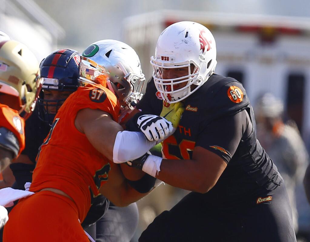 South offensive tackle Andre Dillard of Washington State (60) blocks North defensive end Jalen Jelks of Oregon (97)North long snapper Dan Godsil of Indiana (97) during the first half of the Senior Bowl college football game, Saturday, Jan. 26, 2019, in Mobile, Ala. (AP Photo/Butch Dill)