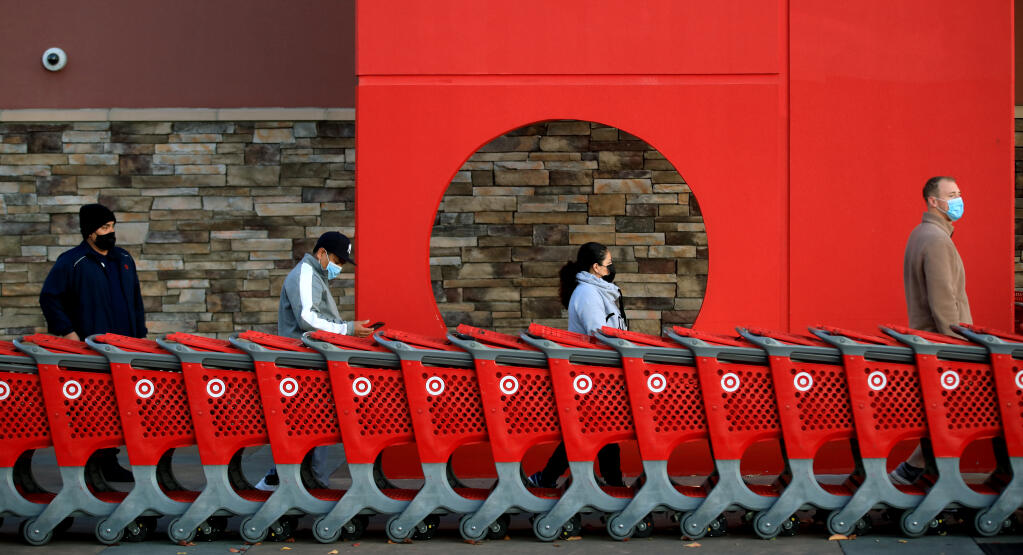 Socially distanced at Target in Coddingtown, customers wait for the doors to open, Nov. 27, 2020, in Santa Rosa. About 50 people were in line when the retailer opened.(Kent Porter / The Press Democrat) 2020