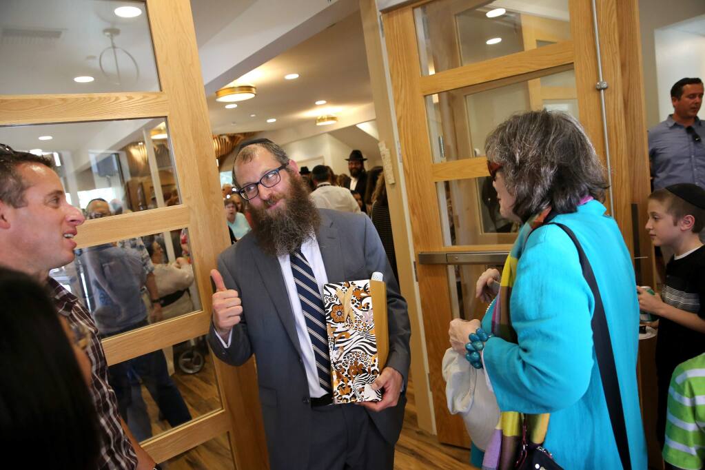 Rabbi Mendel Wolvovsky, center, gives a thumbs up to architect Mike Schwartz during the grand opening of the Joseph Weingarten Sonoma County Chabad Jewish Center in Santa Rosa on Sunday, September 1, 2019. (BETH SCHLANKER/ The Press Democrat)