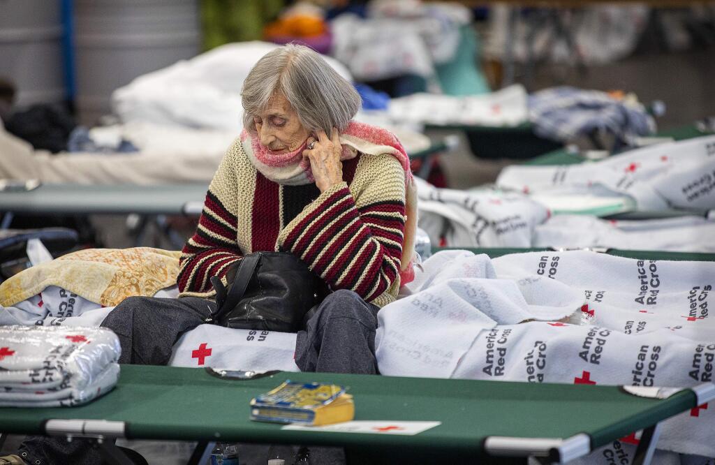 Anna Vandermer evacuated her northern Santa Rosa home to the Red Cross shelter at the Sonoma County Fairgrounds on Sunday. Vandemeer also evacuated during the 2017 Tubbs fire, but the most traumatic event was when was forced her home in the Netherlands in 1944 by the Germans in WWII. (photo by John Burgess/The Press Democrat)