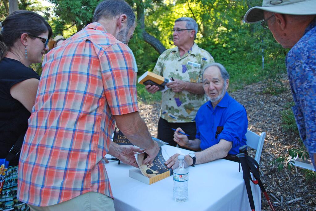 Jared Diamond, author of 'Germs, Guns and Steel,' signs a copy following his July 8, 2017 lecture at Quarryhill Botanical Garden. (Cece Hugo/Quarryhill)