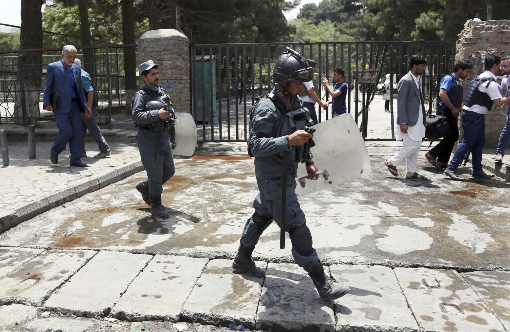 Security personnel arrived at the site of a would-be suicide attack near a park in Kabul, Afghanistan, Monday, July 16, 2018. A would-be suicide attacker was shot and killed by police in Kabul before he was able to get close to a gathering of supporters of the country's first vice president, Gen. Abdul Rashid Dostum, according to police spokesman Hashmat Stanekzai. Dostum is currently in Turkey. (AP Photo/Rahmat Gul)