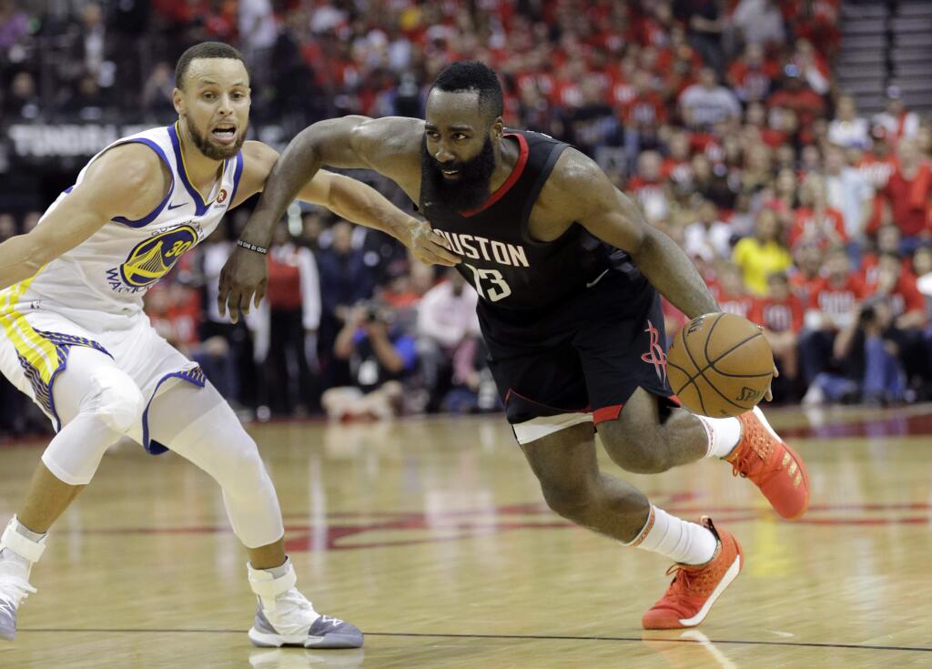 Houston Rockets guard James Harden (13) drives around Golden State Warriors guard Stephen Curry (30) during the second half of Game 1 of the NBA basketball Western Conference Finals, Monday, May 14, 2018, in Houston. (AP Photo/David J. Phillip)