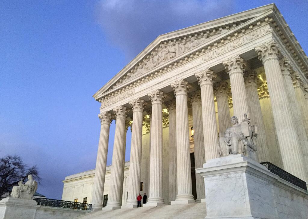 FILE - In this Feb. 13, 2016, file photo, people stand on the steps of the Supreme Court at sunset in Washington. President Donald Trump's efforts to restrict entry into the United States by residents of some mainly Muslim countries have been the subject of lawsuits almost since the moment he announced the first travel ban in January. The latest version of the ban, rolled out Sunday, is certain to attract more legal challenges and is already affecting the high court's review. (AP Photo/Jon Elswick, file)