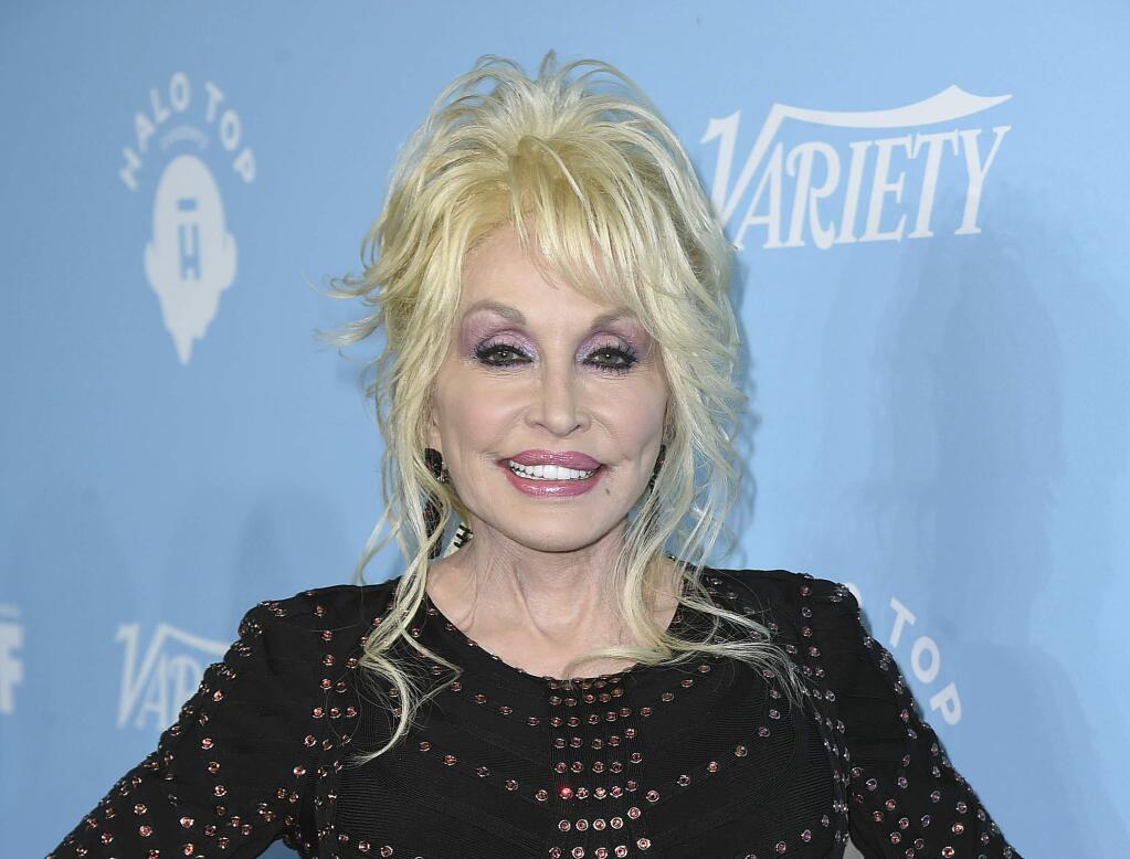 FILE - In this Sept. 15, 2017 file photo, Dolly Parton arrives at the 69th Primetime Emmy Awards Variety and Women in Film pre-Emmy celebration in Los Angeles. (Photo by Jordan Strauss/Invision/AP, File)