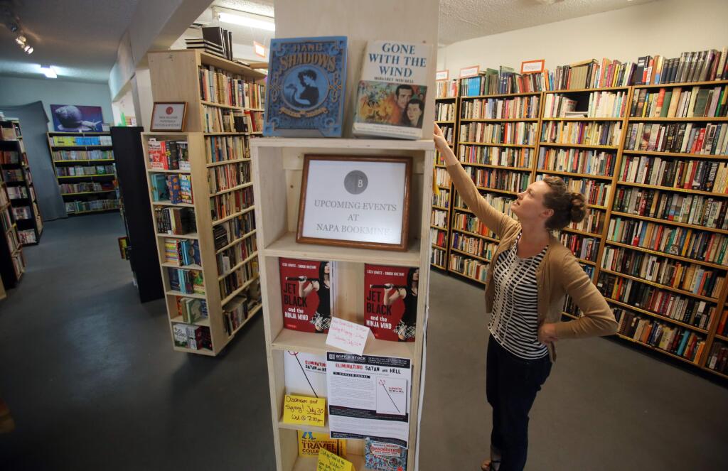 Naomi Chamblin, co-owner of Napa Bookmine in downtown Napa, alphabetizes books, Wednesday, July 23, 2014. (Crista Jeremiason / The Press Democrat)