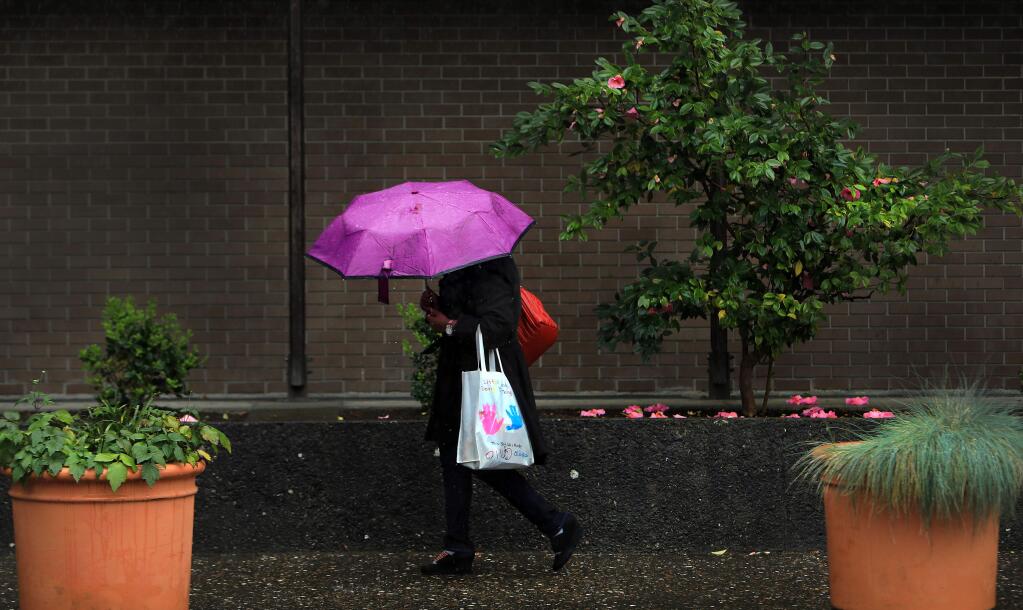 FILE PHOTO: Umbrellas were the fashion of the day in Santa Rosa on April 6. The region finally saw a bit of rain Saturday. (KENT PORTER/ PD)