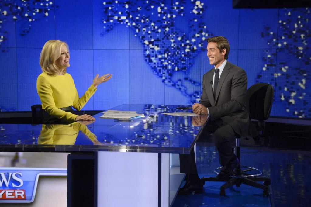 In this Wed., Aug. 27, 2014 photo provided by ABC, Diane Sawyer, left, signs off on her last broadcast as anchor of 'World News,' with new anchor, David Muir, right, looking on in New York. Among the stories Muir will introduce during his first week as ABC's 'World News' anchor in early September, is one he reported about a generation of Syrian refugees missing out on an education. (AP Photo/ABC, Ida Mae Astute, file)