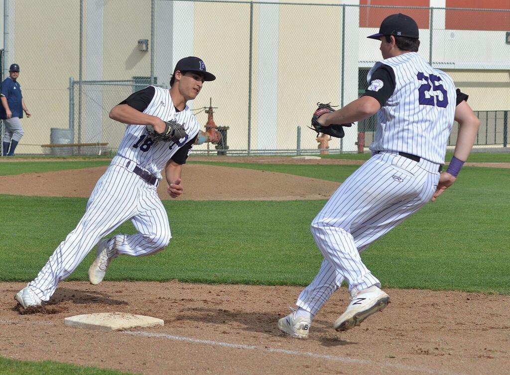 SUMNER FOWLER/FOR THE ARGUS-COURIERPetaluma pitcher Mark Wolbert and first baseman Dan O'Hagen arrive at first base together. O'Hagen made the put out.