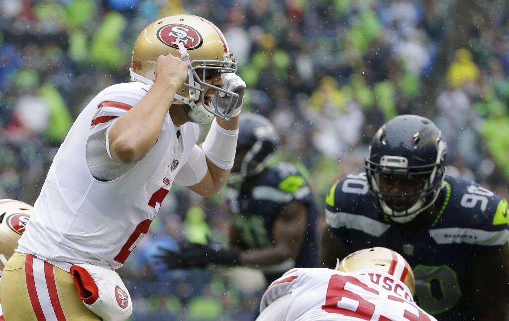 San Francisco 49ers quarterback Brian Hoyer, left, yells on the line of scrimmage in the second half against the Seattle Seahawks, Sunday, Sept. 17, 2017, in Seattle. (AP Photo/Elaine Thompson)