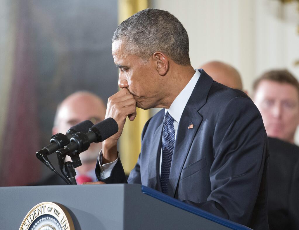 President Barack Obama pauses while speaking Tuesday about steps his administration is taking to reduce gun violence. (PABLO MARTINEZ MONSIVAIS / Associated Press)