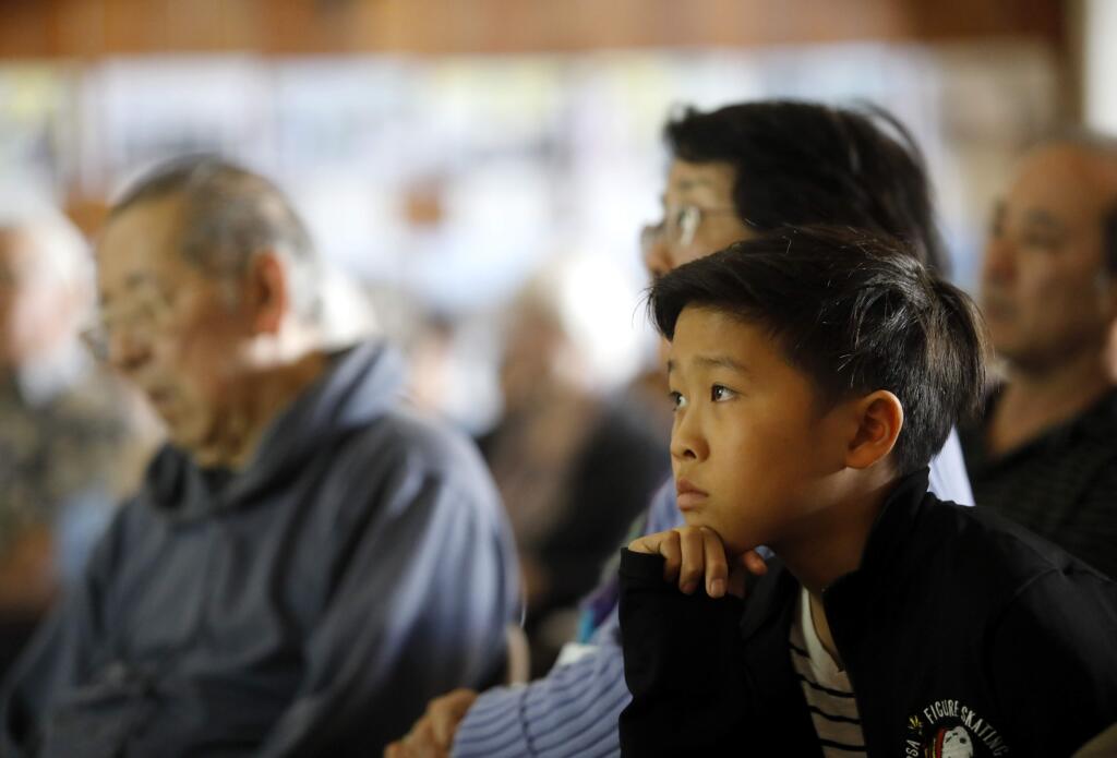 Luke Endo, 12, a second generation Japanese-American, watches a screening of the documentary 'A Flicker In Eternity' at the Enmanji Buddhist Temple Sunday, Feb. 25, 2018 in Sebastopol, California. (BETH SCHLANKER/The Press Democrat)