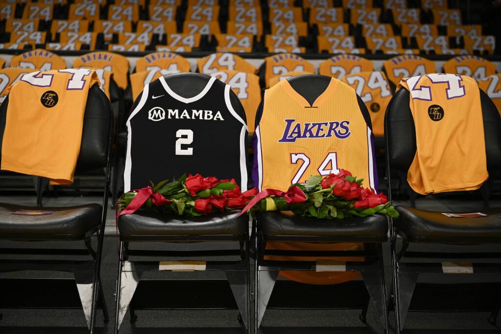 In this Jan. 31, 2020, file photo, the jerseys of late Los Angeles Laker Kobe Bryant, right, and his daughter Gianna are draped on the seats the two last sat on at Staples Center, prior to the Lakers' game against the Portland Trail Blazers in Los Angeles. (AP Photo/Kelvin Kuo, File)