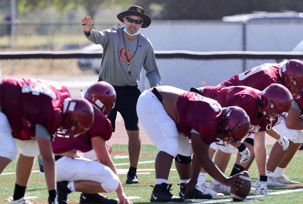 Cardinal Newman varsity football head coach Richard Sanchez directs his team during practice in Santa Rosa on Tuesday, August 24, 2021.  (Christopher Chung/ The Press Democrat)