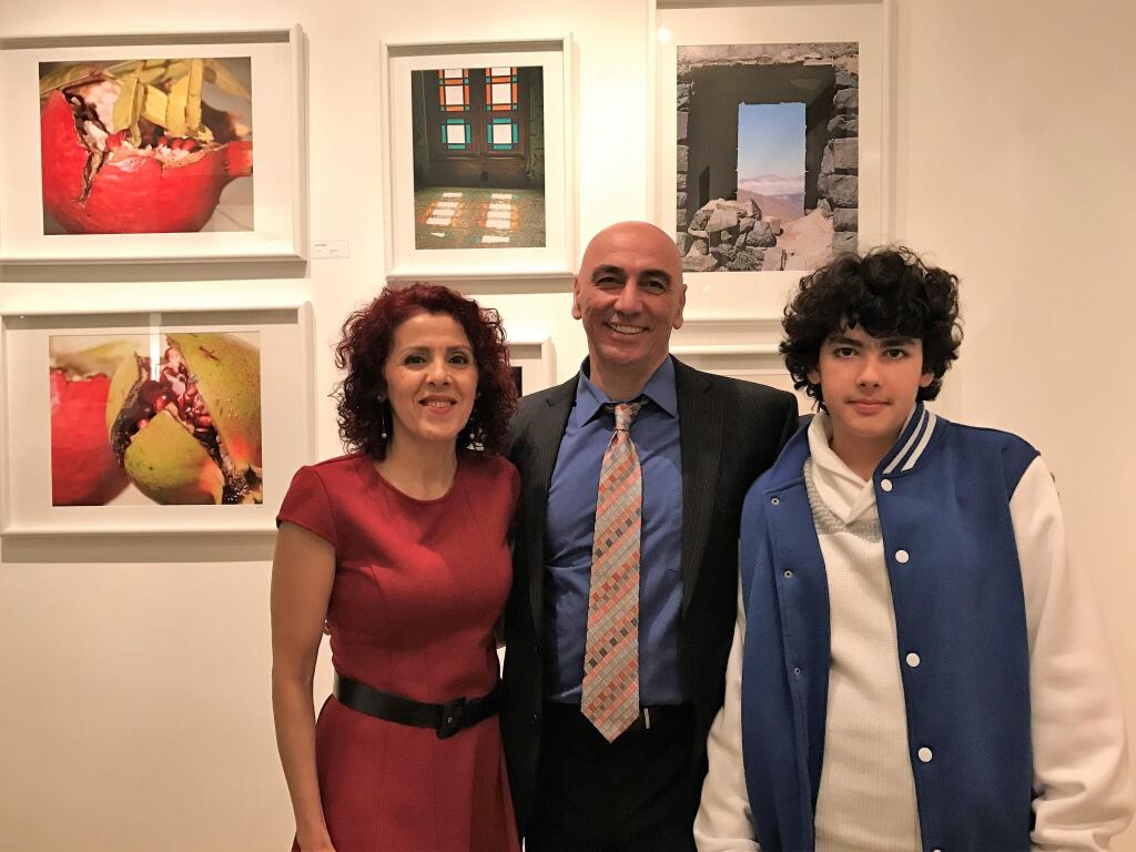 Aida Dargahi, Tony Kashani, Idan Kashani, with some of Aida's photos in the background by Aida PHOTO BY AIDA DARGAHI