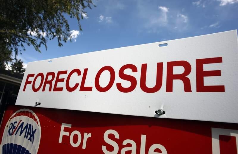 A foreclosure sign stands on top of a sale sign in 2008. (AP Photo/David Zalubowski)