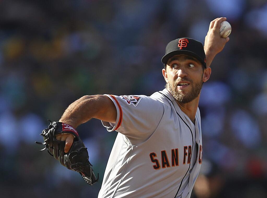 San Francisco Giants pitcher Madison Bumgarner works against the Oakland Athletics during the first inning of a baseball game Saturday, July 21, 2018, in Oakland, Calif. (AP Photo/Ben Margot)