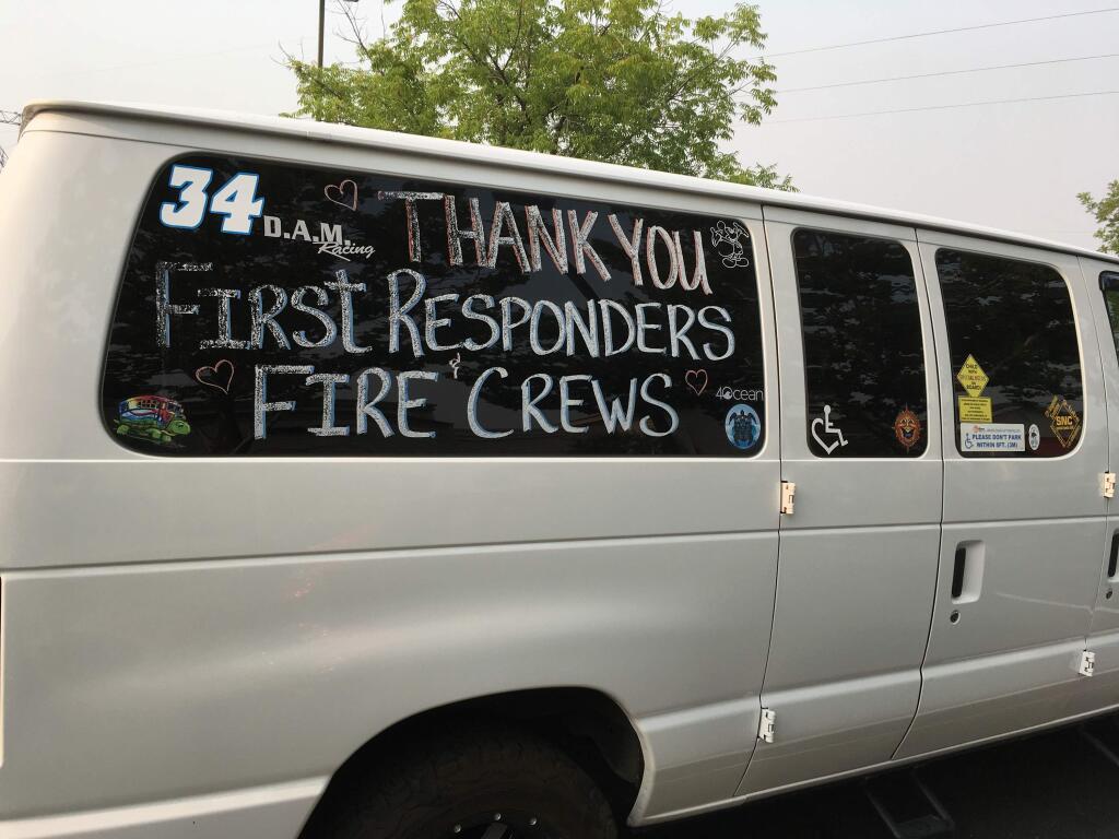 A thank you to fire crews and first responders is shown on a van in Redding, Calif., Sunday, July 29, 2018. Fire crews faced many uncertainties Sunday as they struggled to corral a deadly blaze in Northern California that left thousands of dazed evacuees reeling as they tried to take care of themselves and their pets. Crews endured hot temperatures and remained wary of the possibility of gusty winds, said Anthony Romero, a spokesman for the California Department of Forestry and Fire Protection. (AP Photo/Martha Mendoza)
