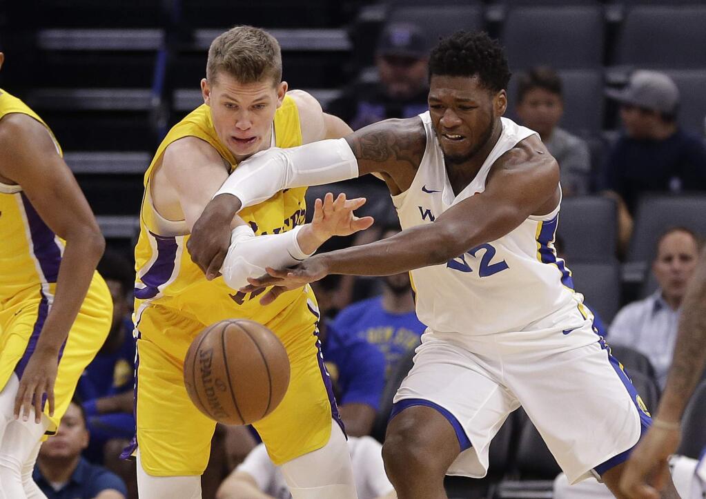 Los Angeles Lakers center Moritz Wagner, left, and Golden State Warriors forward Marcus Derrickson scramble for the ball during the first half of an NBA summer league game Thursday, July 5, 2018, in Sacramento. (AP Photo/Rich Pedroncelli)