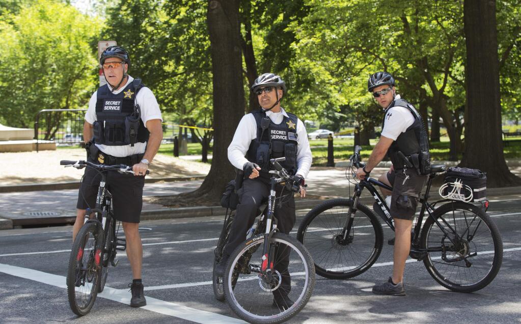A uniformed Secret Service Police officer patrol on bikes near the White House in Washington, Thursday, May 14, 2015, during a lockdown. A federal law enforcement official says a man has been arrested after trying to launch a drone outside the White House fence. (AP Photo/Manuel Balce Ceneta)
