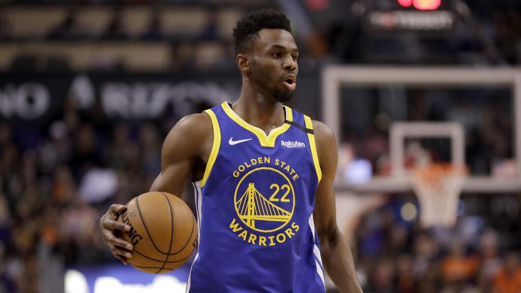 Golden State Warriors guard Andrew Wiggins looks to pass against the Phoenix Suns during the second half Wednesday, Feb. 12, 2020, in Phoenix. (AP Photo/Matt York)