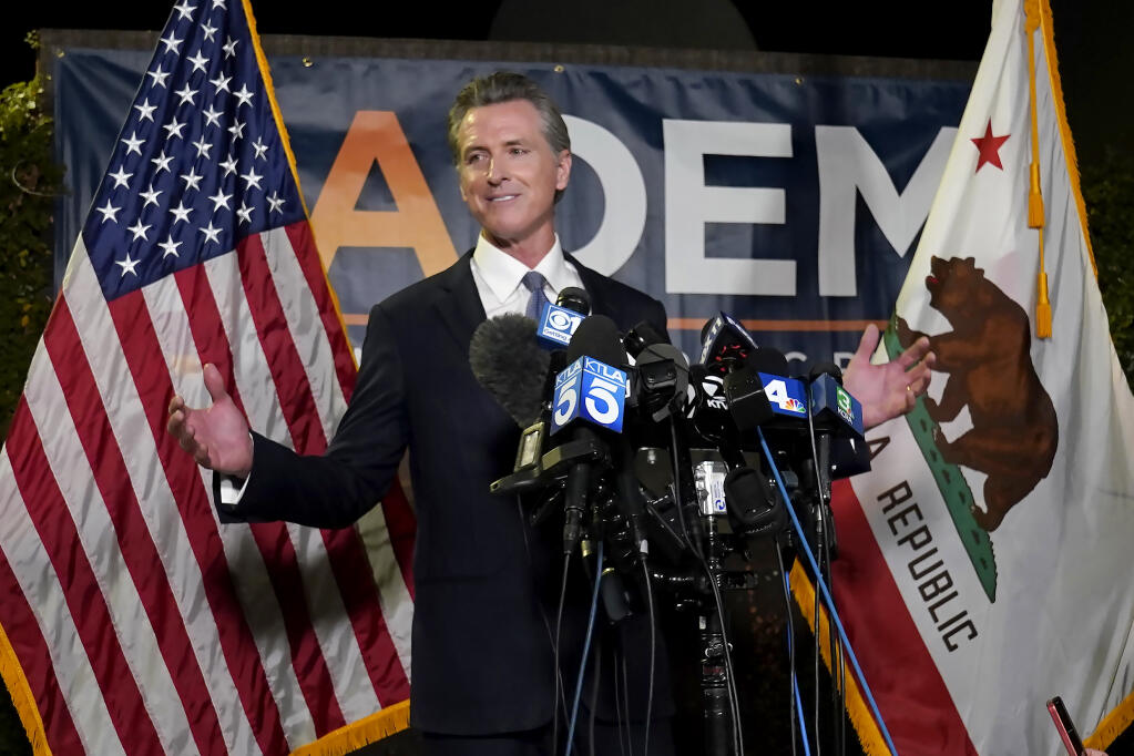 California Gov. Gavin Newsom addresses reporters, after beating back the recall  attempt that aimed to remove him from office, at the John L. Burton California Democratic Party headquarters in Sacramento, Calif., Tuesday, Sept. 14, 2021. (AP Photo/Rich Pedroncelli)