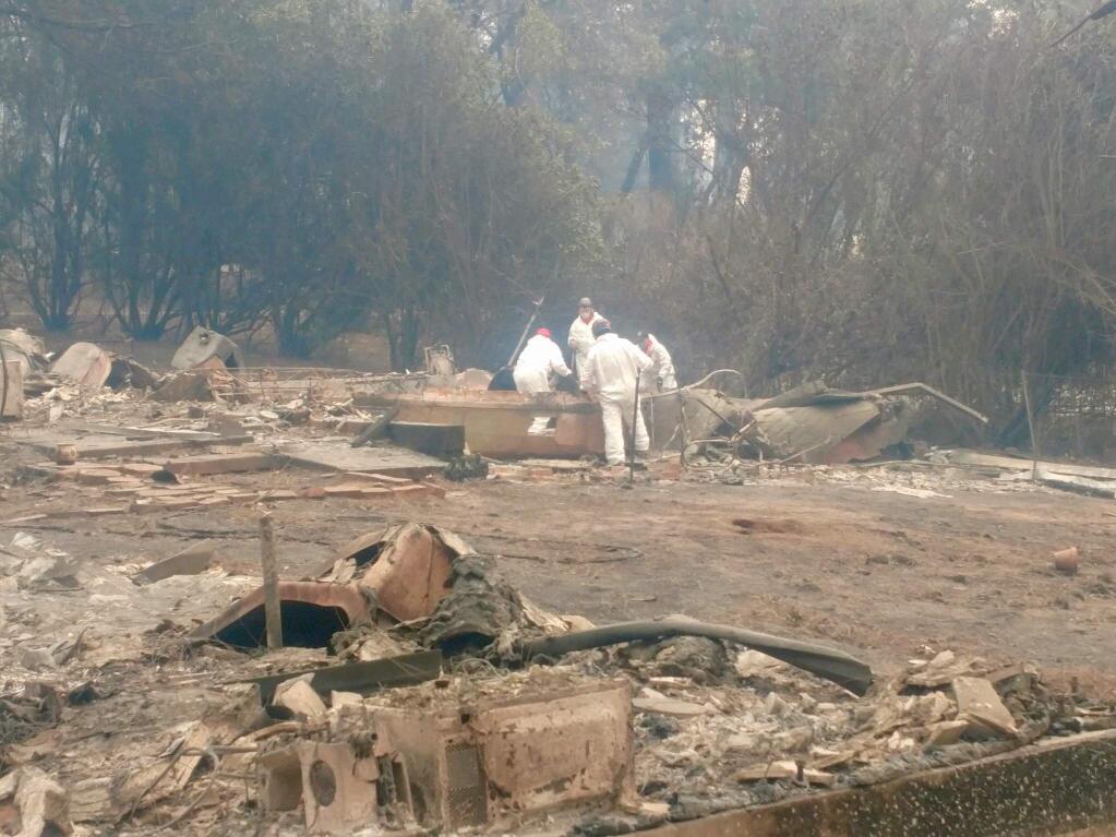 The Sonoma County Sheriff's volunteer search and rescue squad examines a property burned in the Camp fire in Butte County. (Courtesy photo)